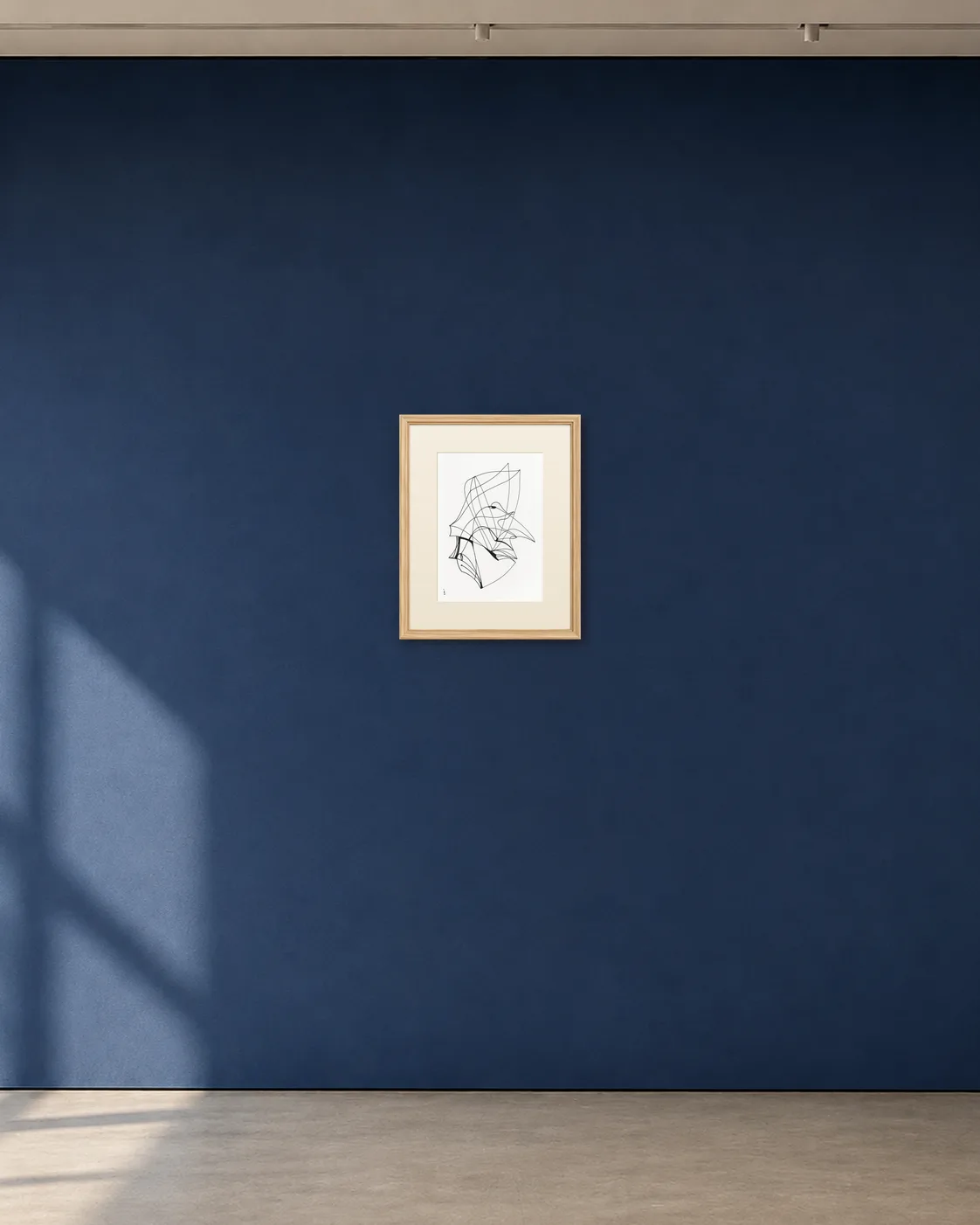 Folded Flight shown framed on a deep blue gallery wall